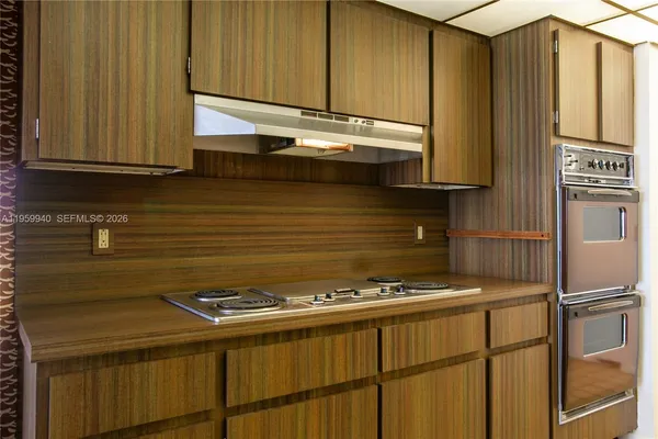 a kitchen with granite countertop cabinets stainless steel appliances and a sink