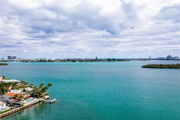 a view of a lake with houses in the back