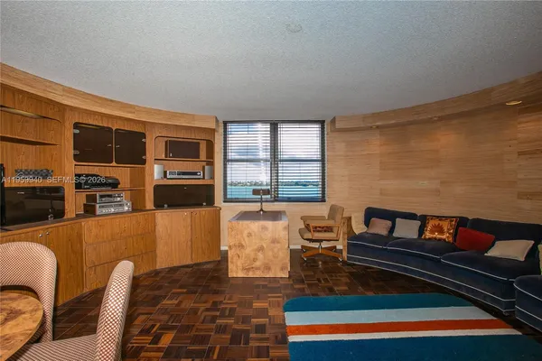 a living room with furniture and a book shelf