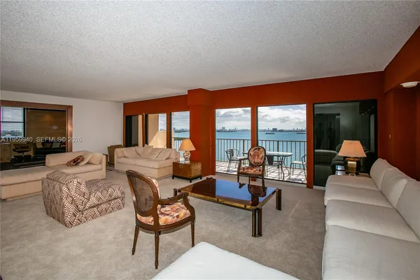 a living room with furniture and floor to ceiling window