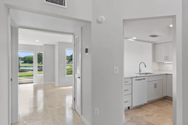 a kitchen with sink a microwave and cabinets