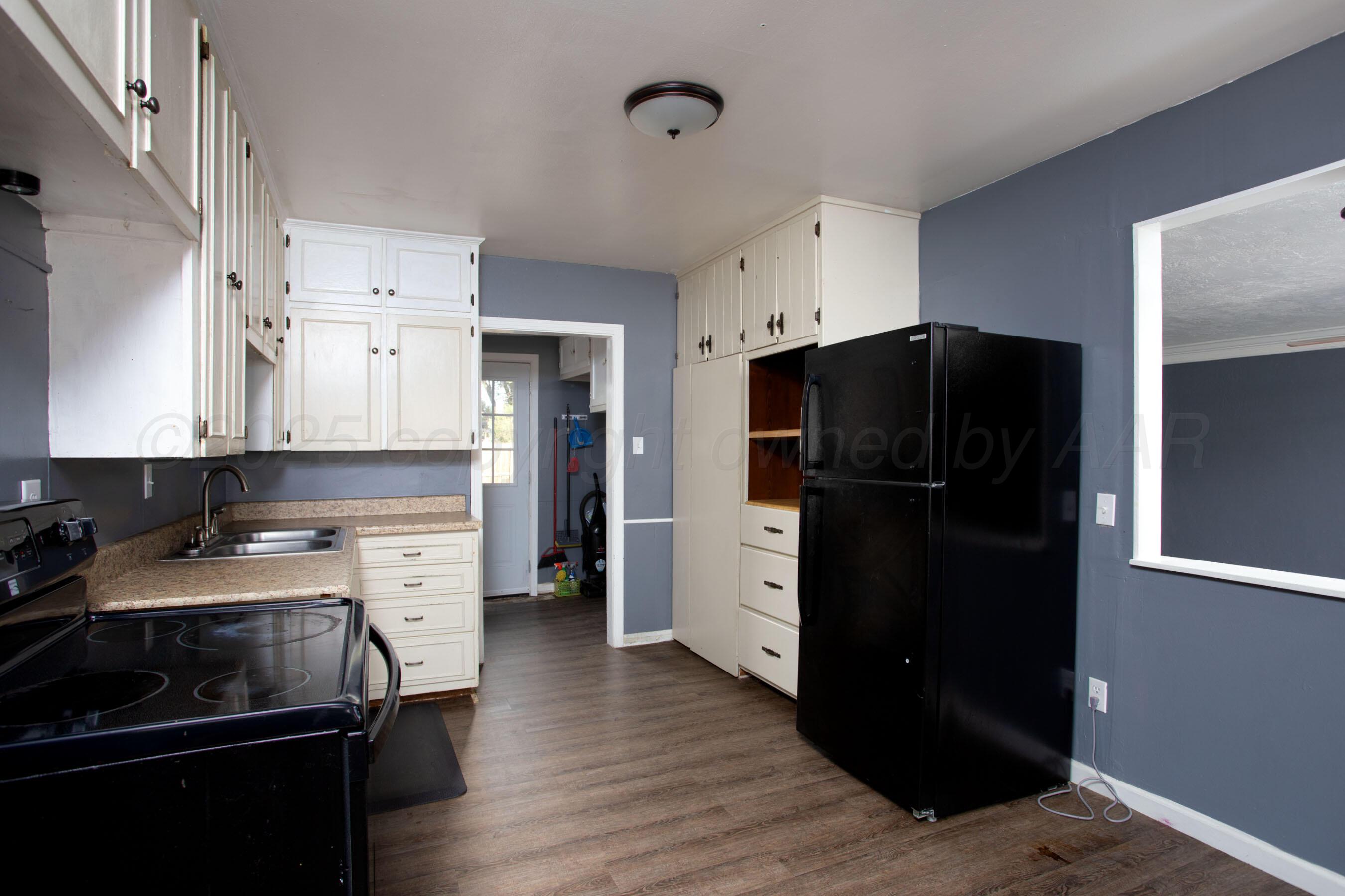 4630 South Hayden Street Amarillo, TX 79110 - Photo 12 of 26 a kitchen with a refrigerator and a stove top oven