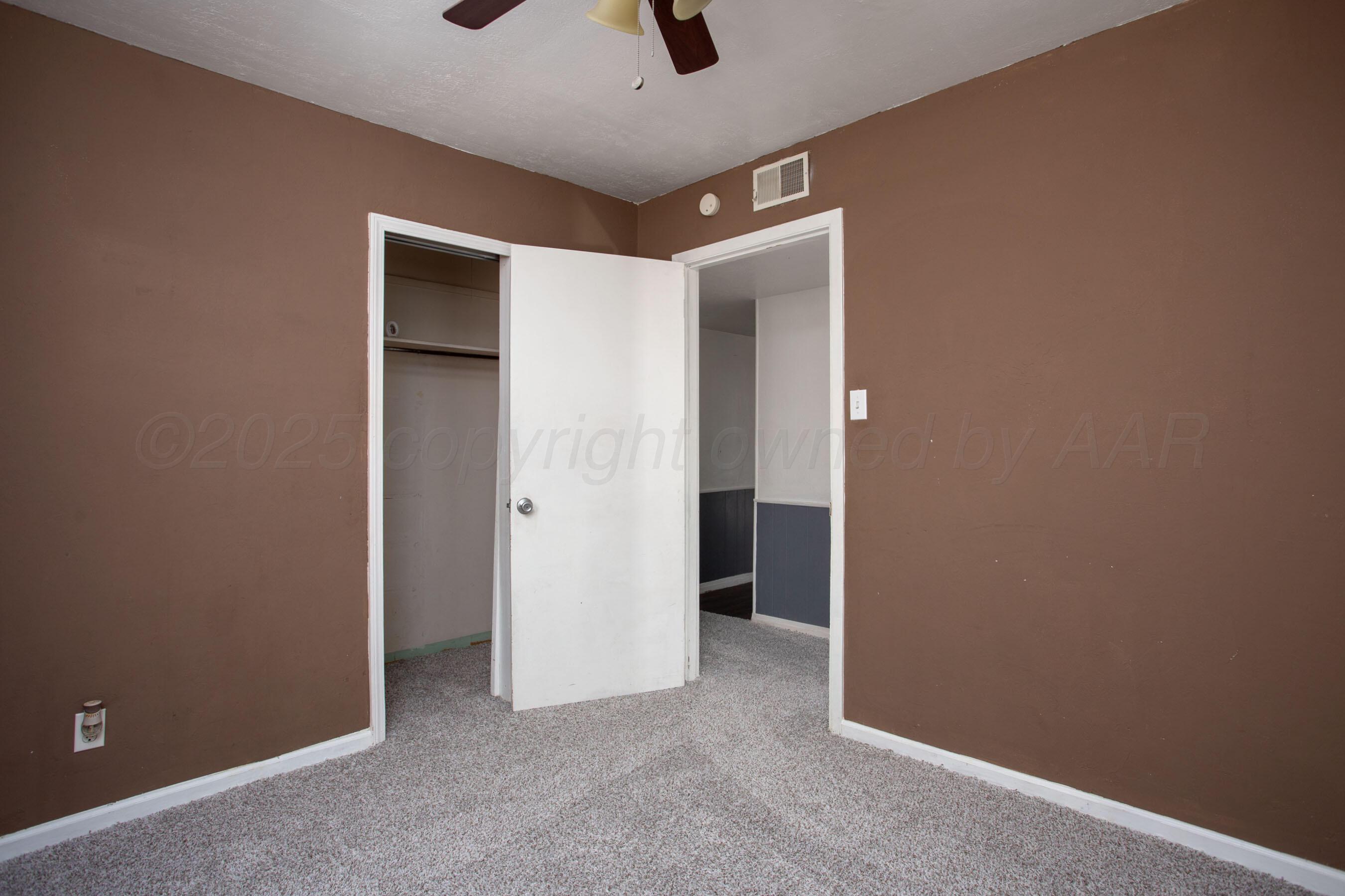 4630 South Hayden Street Amarillo, TX 79110 - Photo 15 of 26 an empty room with windows and closet