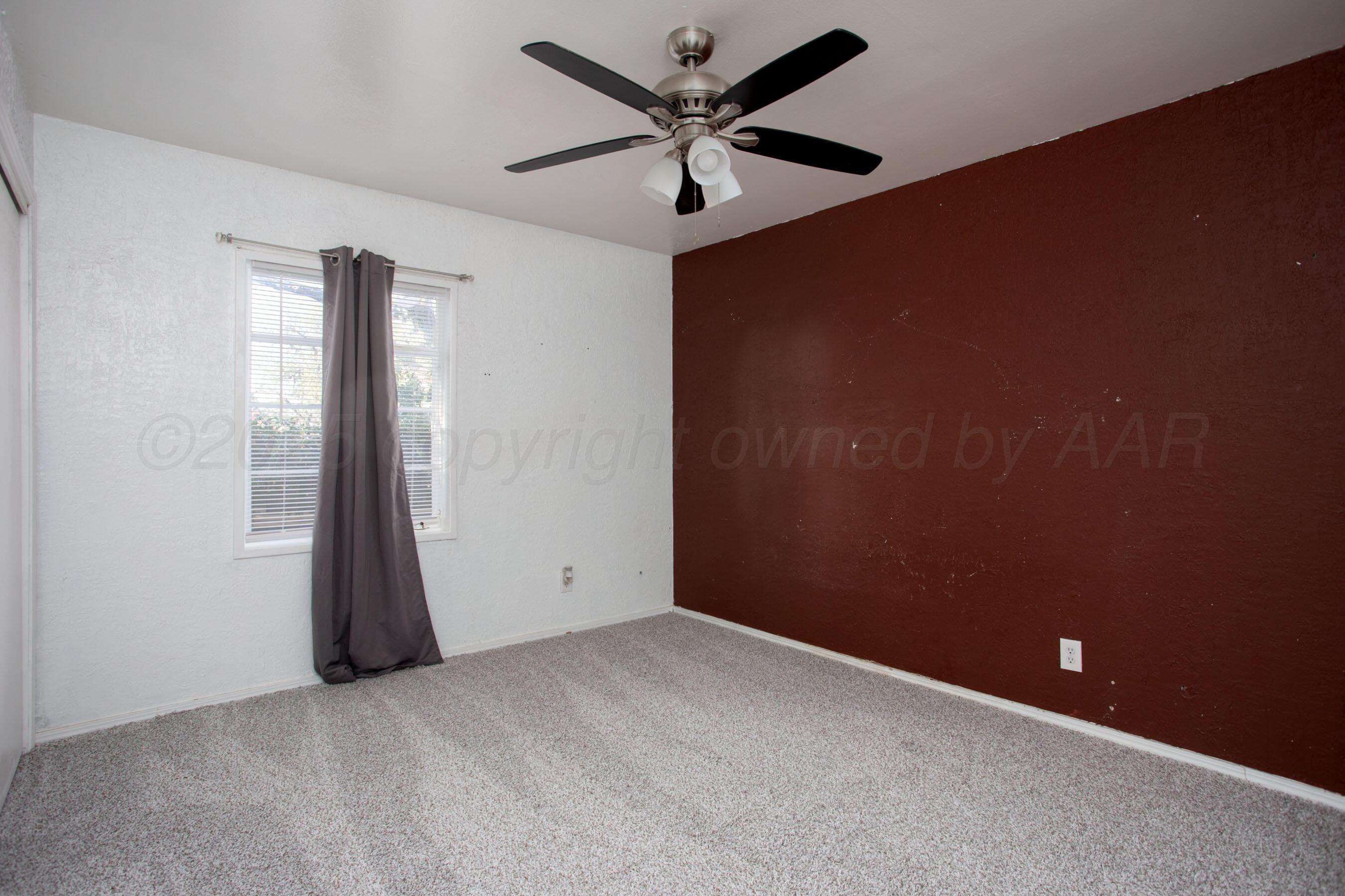 4630 South Hayden Street Amarillo, TX 79110 - Photo 18 of 26 an empty room with closet and a chandelier fan