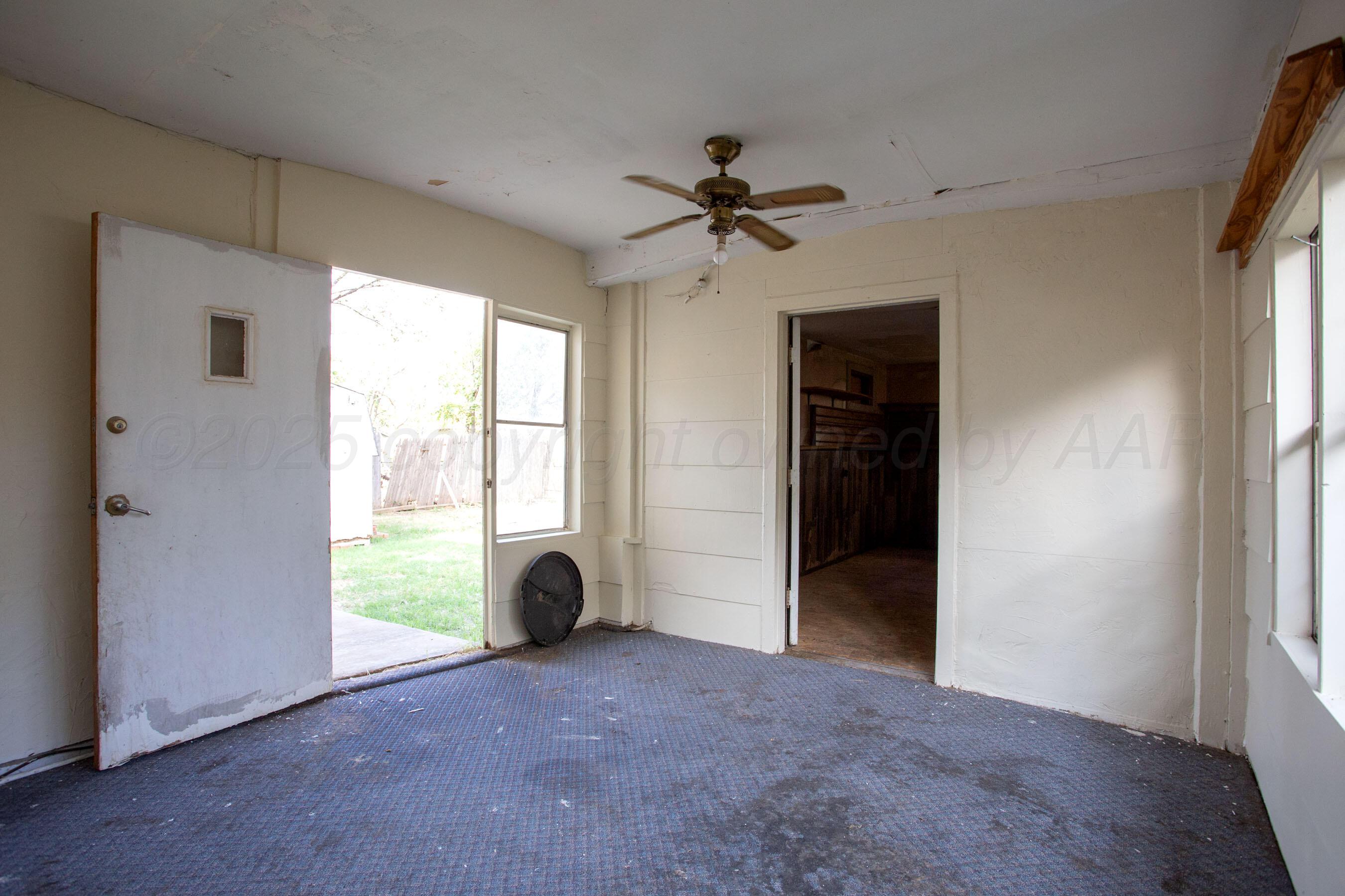 4630 South Hayden Street Amarillo, TX 79110 - Photo 24 of 26 a view of a livingroom with a ceiling fan and window