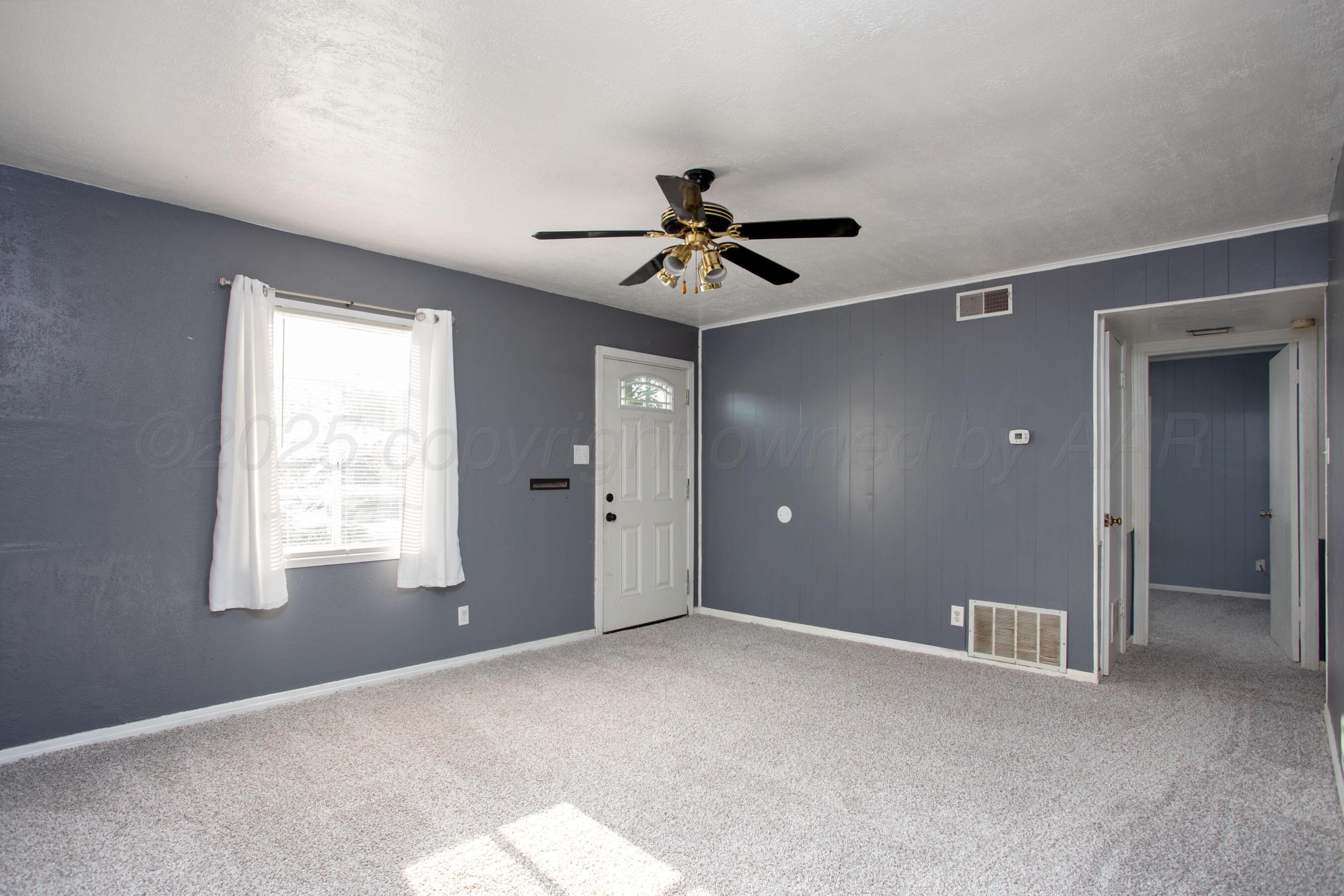4630 South Hayden Street Amarillo, TX 79110 - Photo 4 of 26 a view of an empty room with a window