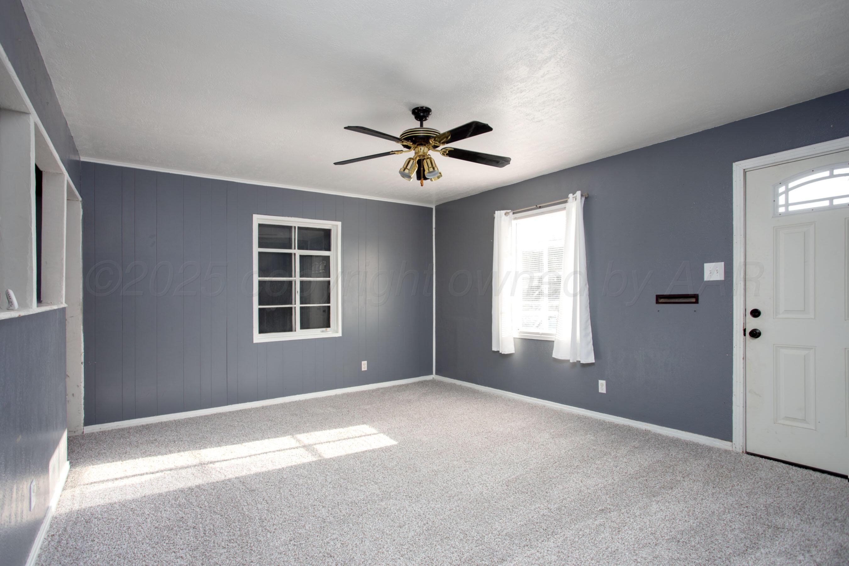4630 South Hayden Street Amarillo, TX 79110 - Photo 6 of 26 a view of a livingroom with a ceiling fan and window