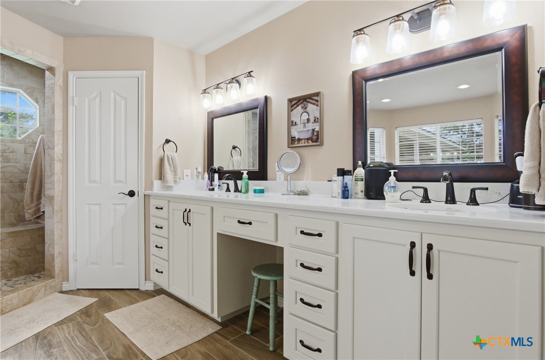 642 Phantom Rider Trail Spring Branch, TX 78070 - Photo 15 of 41 a bathroom with double vanity sink and mirror