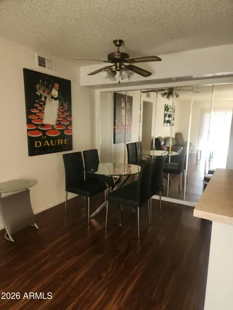 a view of a dining room with furniture wooden floor and chandelier