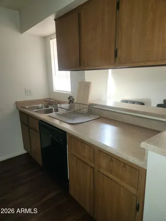 a kitchen with a sink cabinets and a window