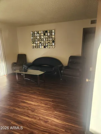 a view of a workspace room with wooden floor