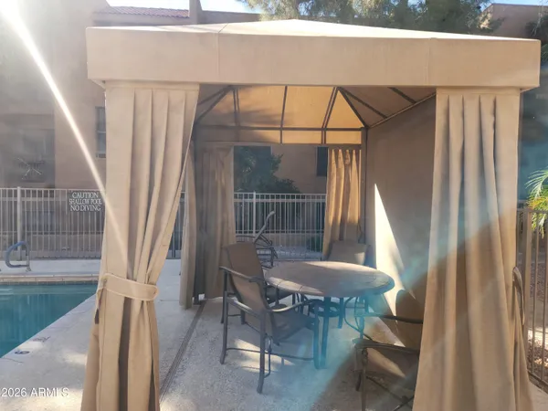 a balcony with table and chairs