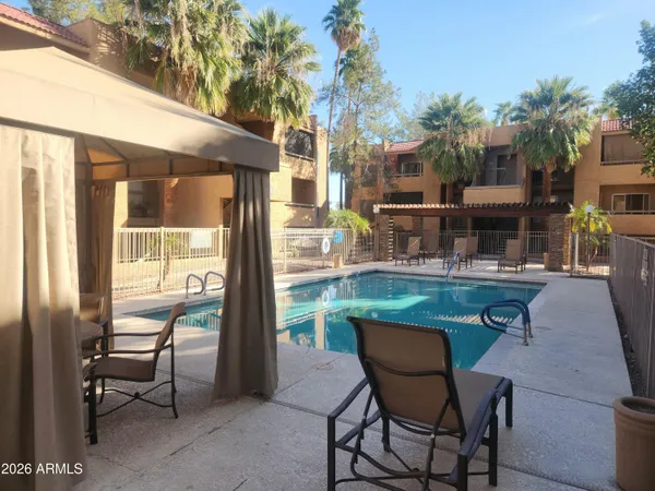 a backyard of a house with table and chairs