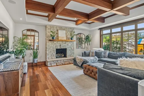 a living room with furniture and large windows
