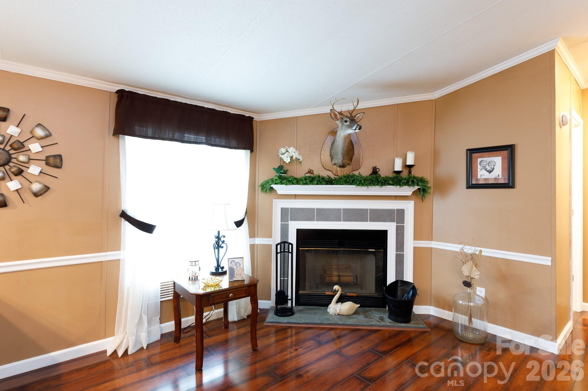 652 Sutton Spring Road York, SC 29745 - Photo 8 of 28 a living room with furniture and a fireplace