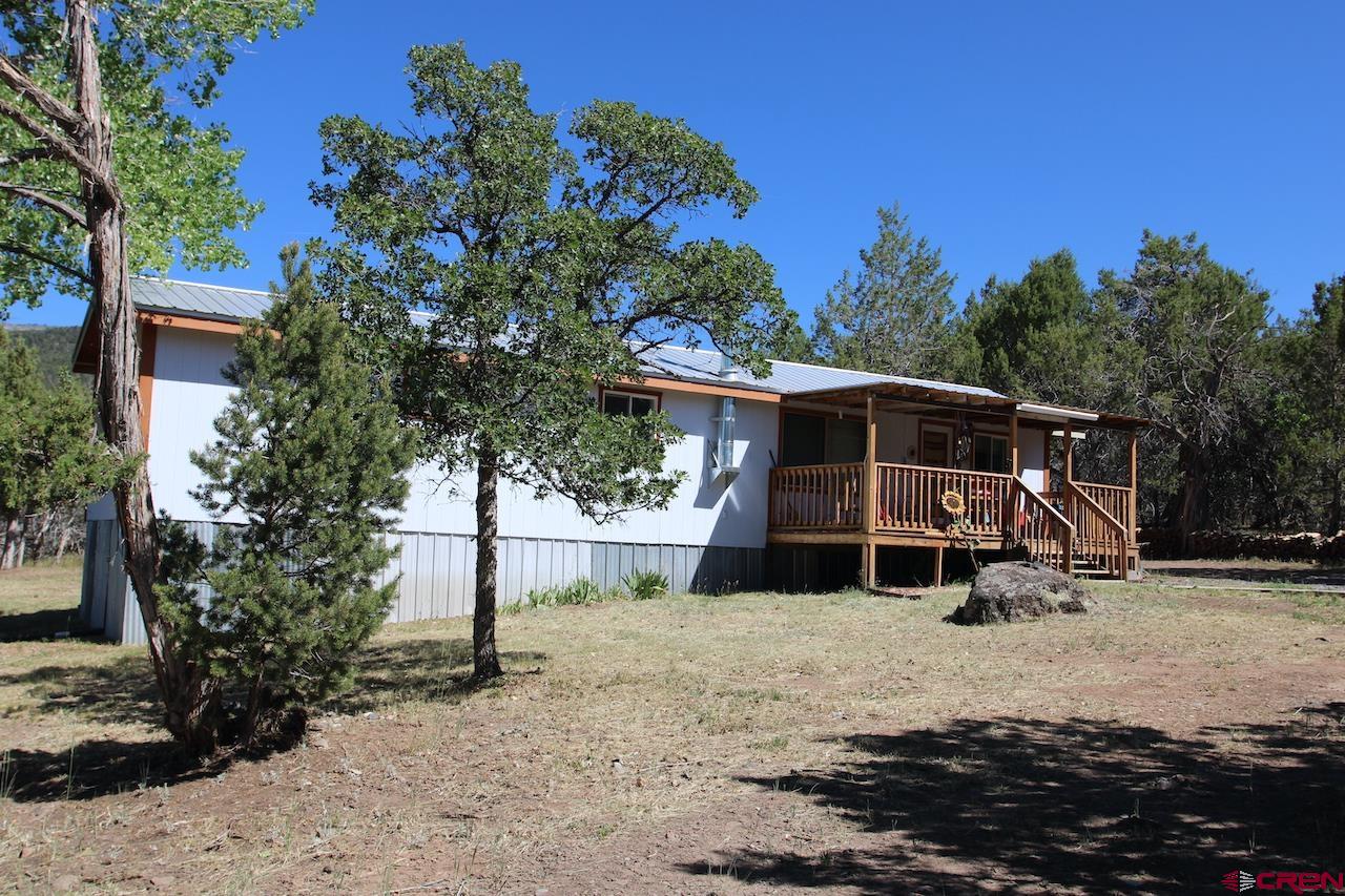 20992 Uintah Road Cedaredge, CO 81413 - Photo 1 of 30 a front view of a house with a yard