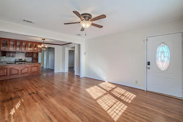 a view of empty room with wooden floor