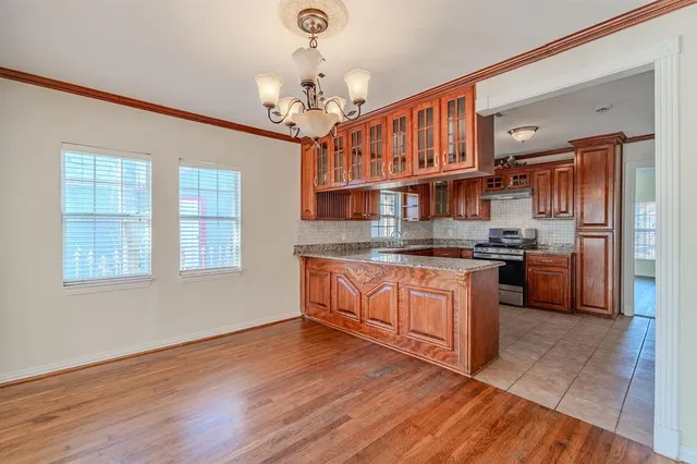 a kitchen with stainless steel appliances granite countertop a stove and cabinets