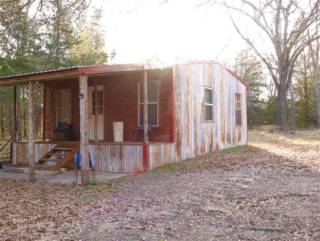 a view of a house with backyard and wooden fence