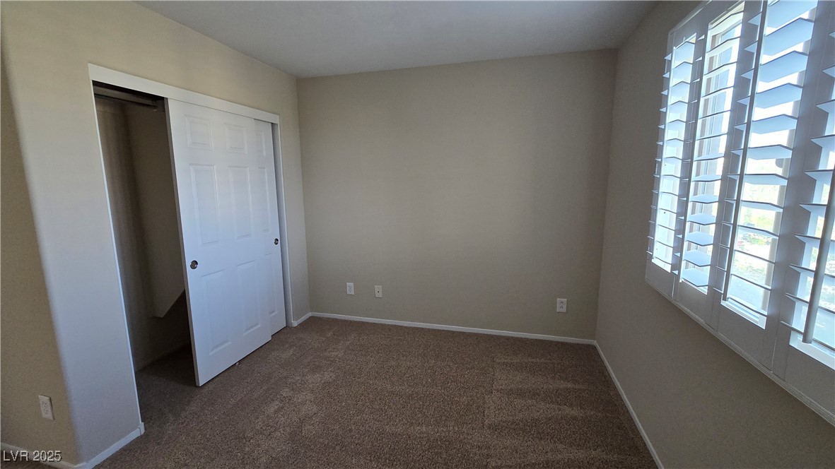 2737 Rimbaud Street Henderson, NV 89044 - Photo 33 of 49 Unfurnished bedroom with carpet floors, a closet, and baseboards