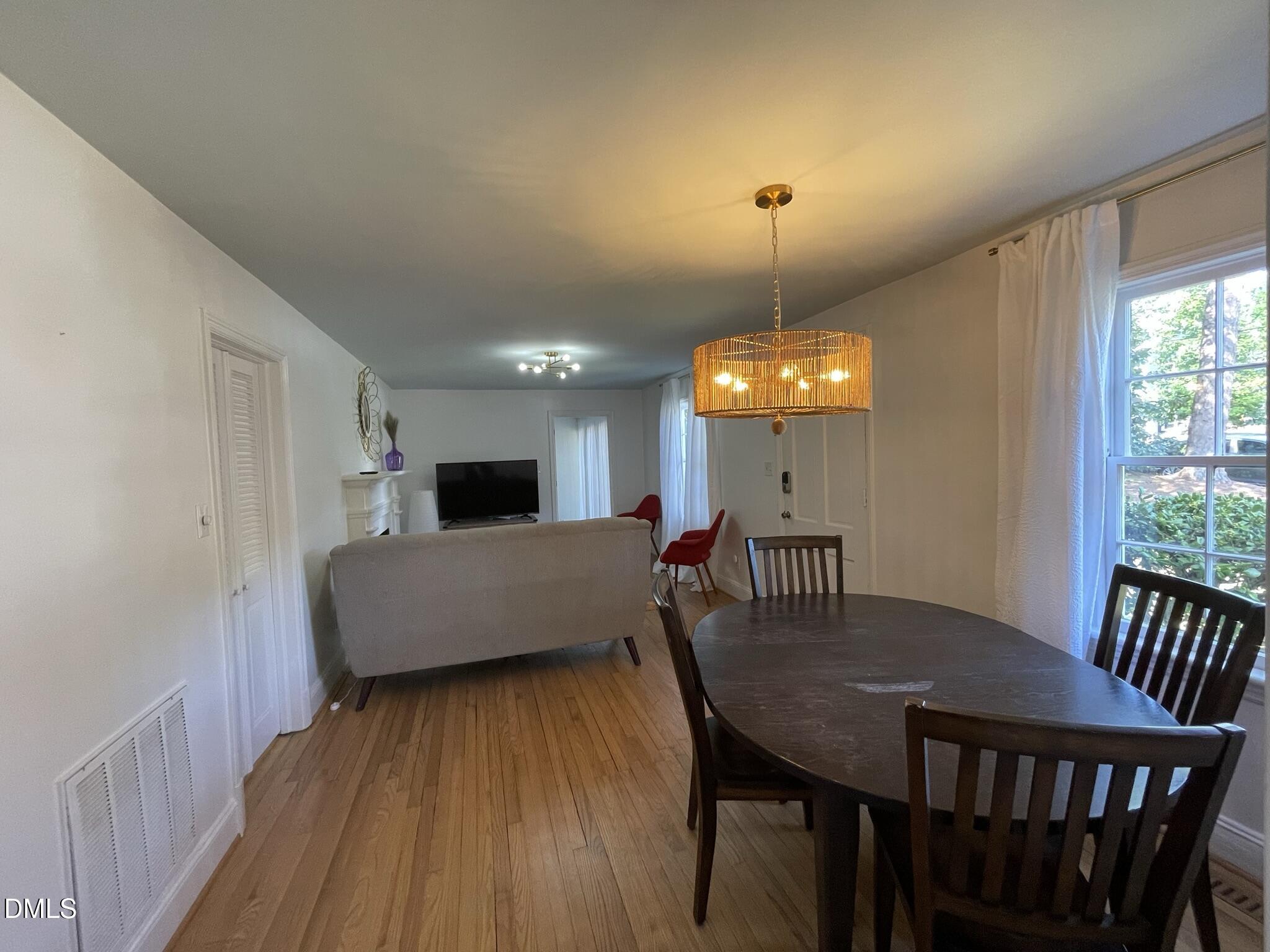 1009 Canterbury Road Raleigh, NC 27607 - Photo 29 of 31 a view of a dining room with furniture window and wooden floor