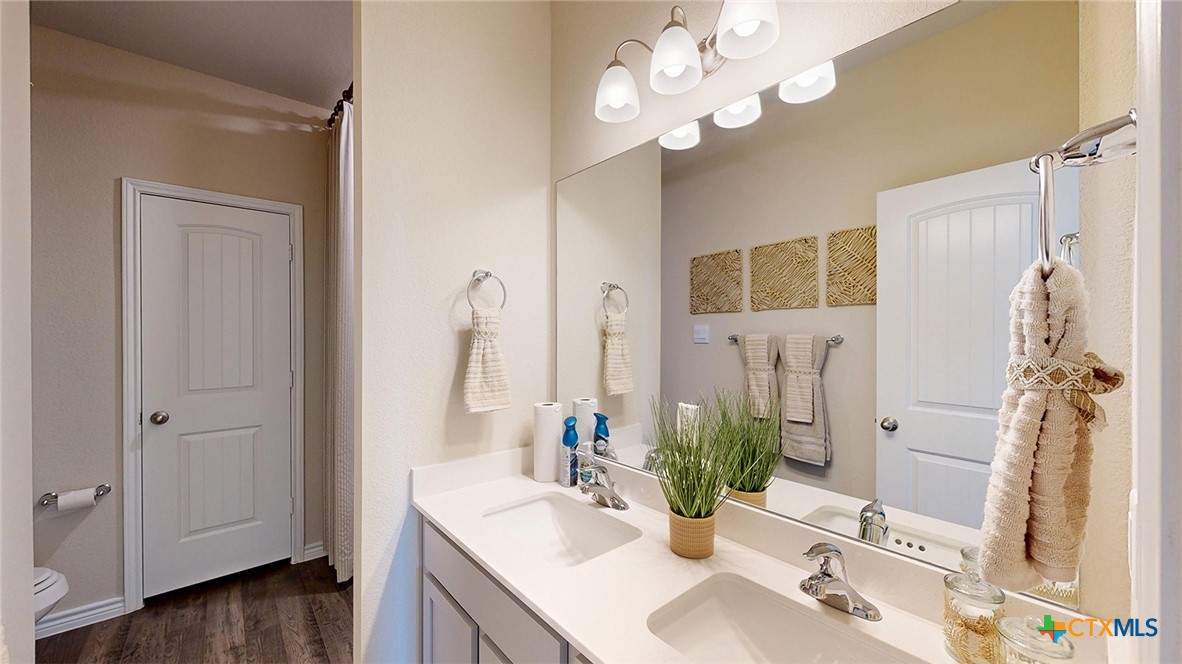 14096 Carsten Loop Salado, TX 76571 - Photo 17 of 32 a bathroom with a sink vanity granite and a mirror