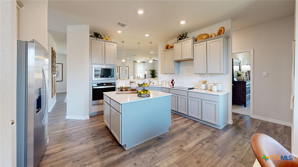 14096 Carsten Loop Salado, TX 76571 - Photo 5 of 32 a kitchen with cabinets and wooden floor