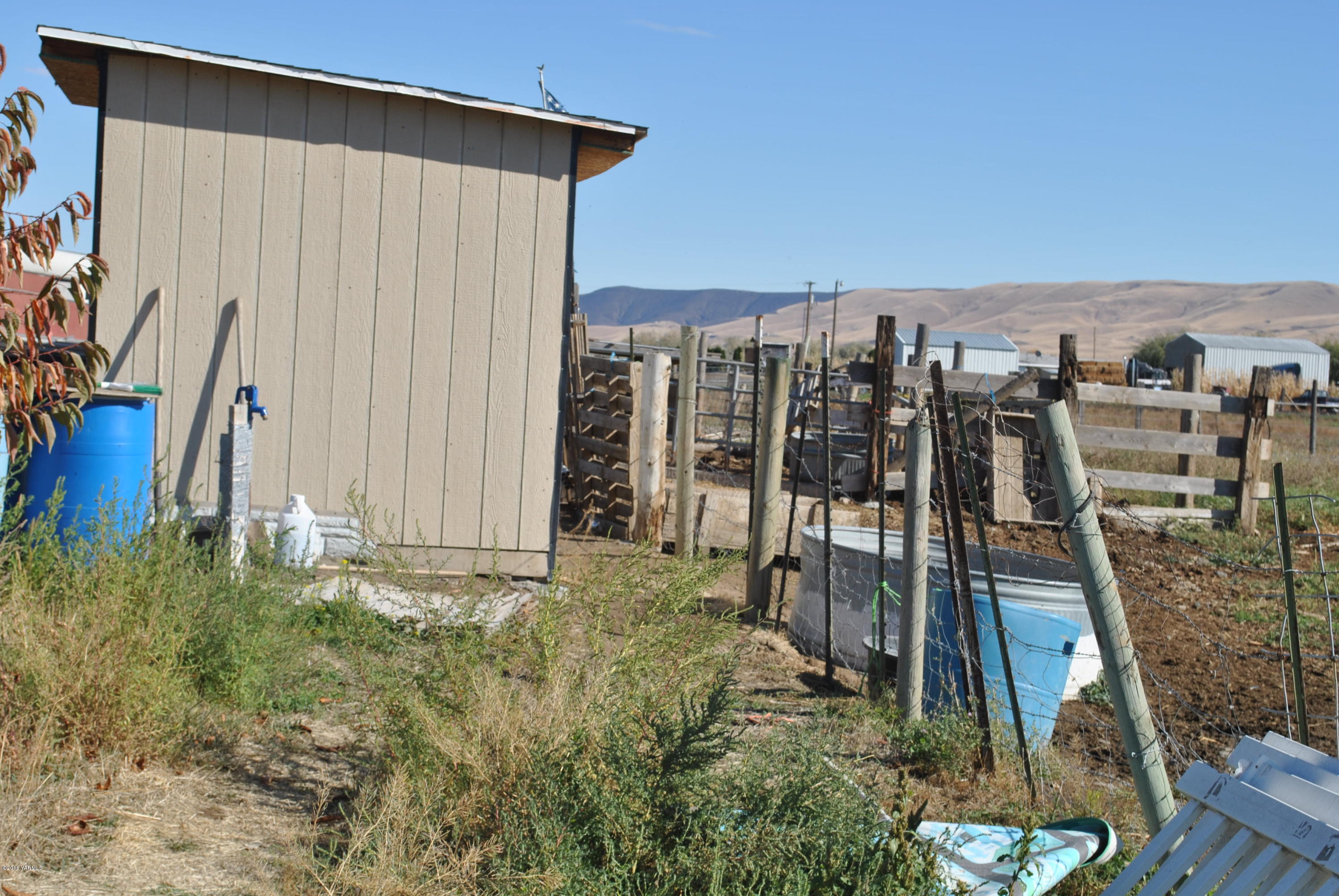 Sr-22 Bus Road Mabton, WA 98935 - Photo 3 of 15 a view of a house with backyard and sitting area