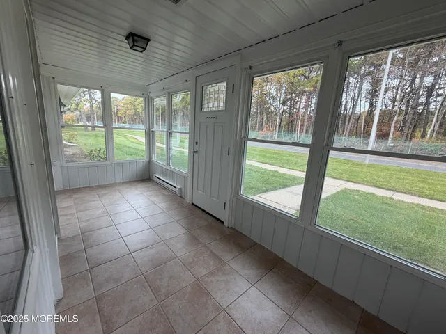 a view of an empty room with a window and a floor to ceiling window