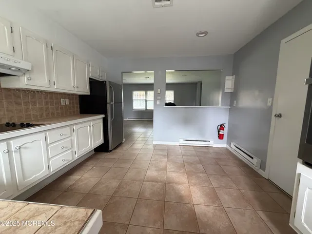 a view of a kitchen with electric appliances