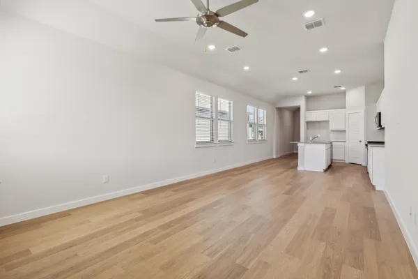 a view of a kitchen with a sink and wooden floor