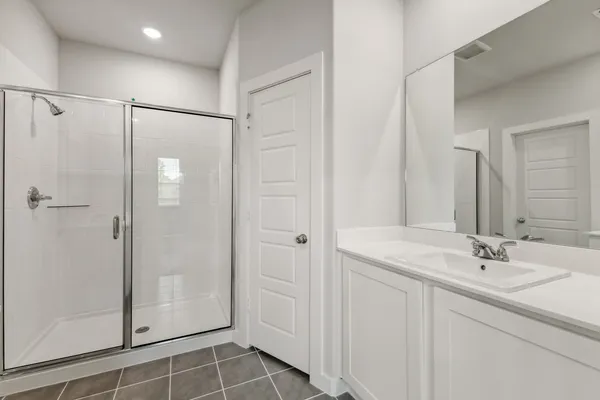 a bathroom with a shower sink and mirror