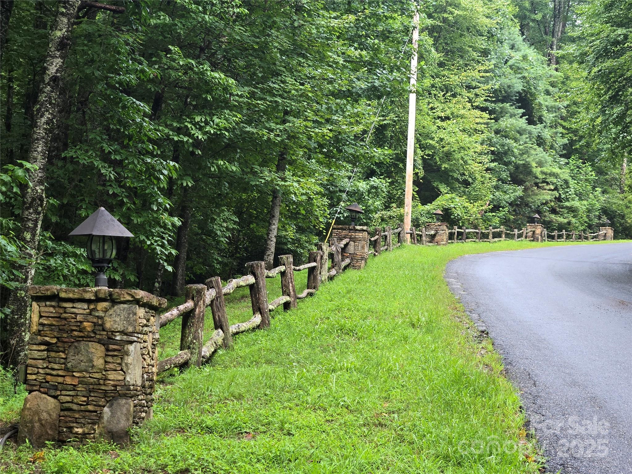 303 Ladd Ridge Road Rosman, NC 28772 - Photo 26 of 32 a view of a backyard with chairs