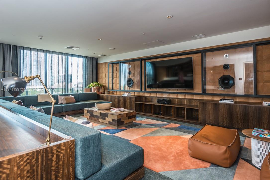 121 Northeast 34th Street, Unit 901 Miami, FL 33137 - Photo 16 of 29 a living room with furniture and a flat screen tv