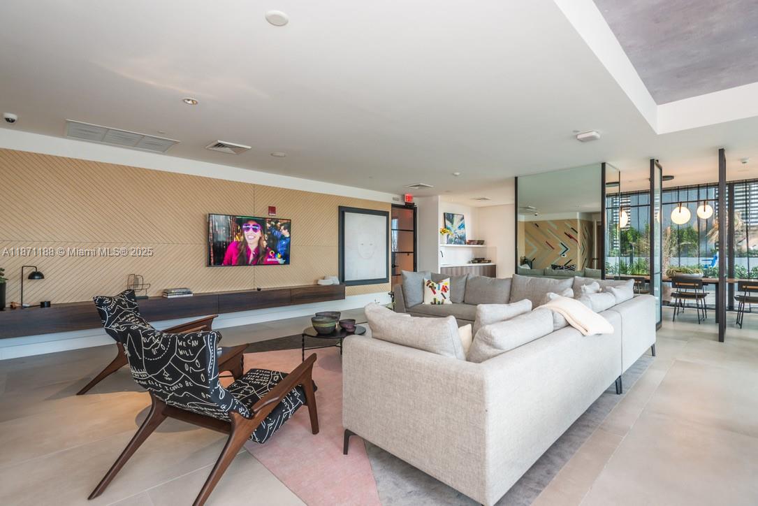 121 Northeast 34th Street, Unit 901 Miami, FL 33137 - Photo 17 of 29 a living room with furniture and a flat screen tv