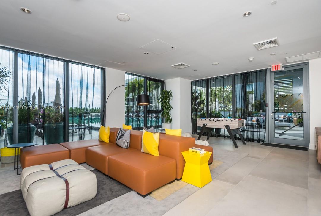 121 Northeast 34th Street, Unit 901 Miami, FL 33137 - Photo 21 of 29 a living room with furniture and a large window
