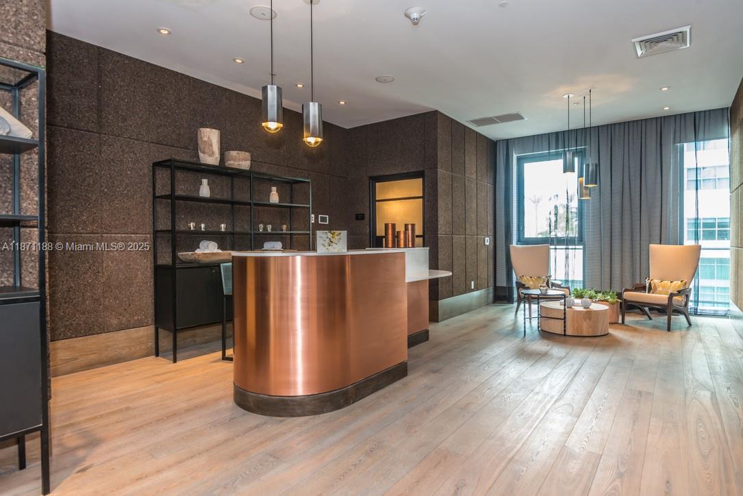 121 Northeast 34th Street, Unit 901 Miami, FL 33137 - Photo 22 of 29 a view of a dining room with furniture window and wooden floor