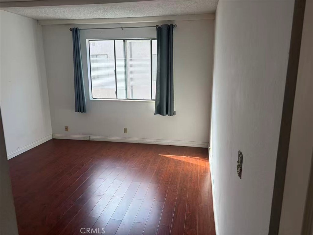 116 East Commonwealth Avenue Alhambra, CA 91801 - Photo 14 of 15 an empty room with wooden floor and windows