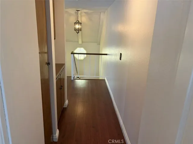 a view of hallway with wooden floor