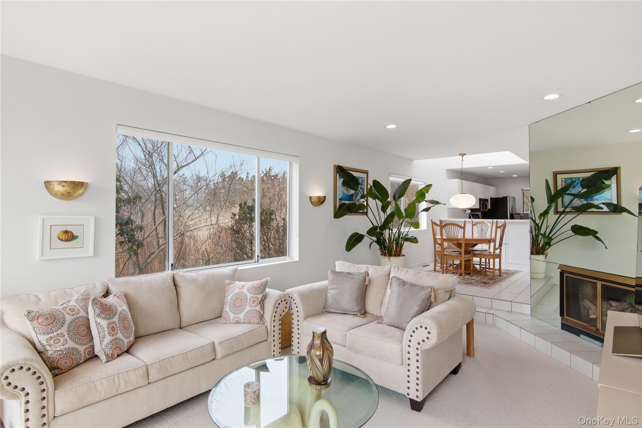 23 Library Avenue, Unit 1 Westhampton Beach, NY 11978 - Photo 11 of 24 Living area with recessed lighting and a fireplace and water views