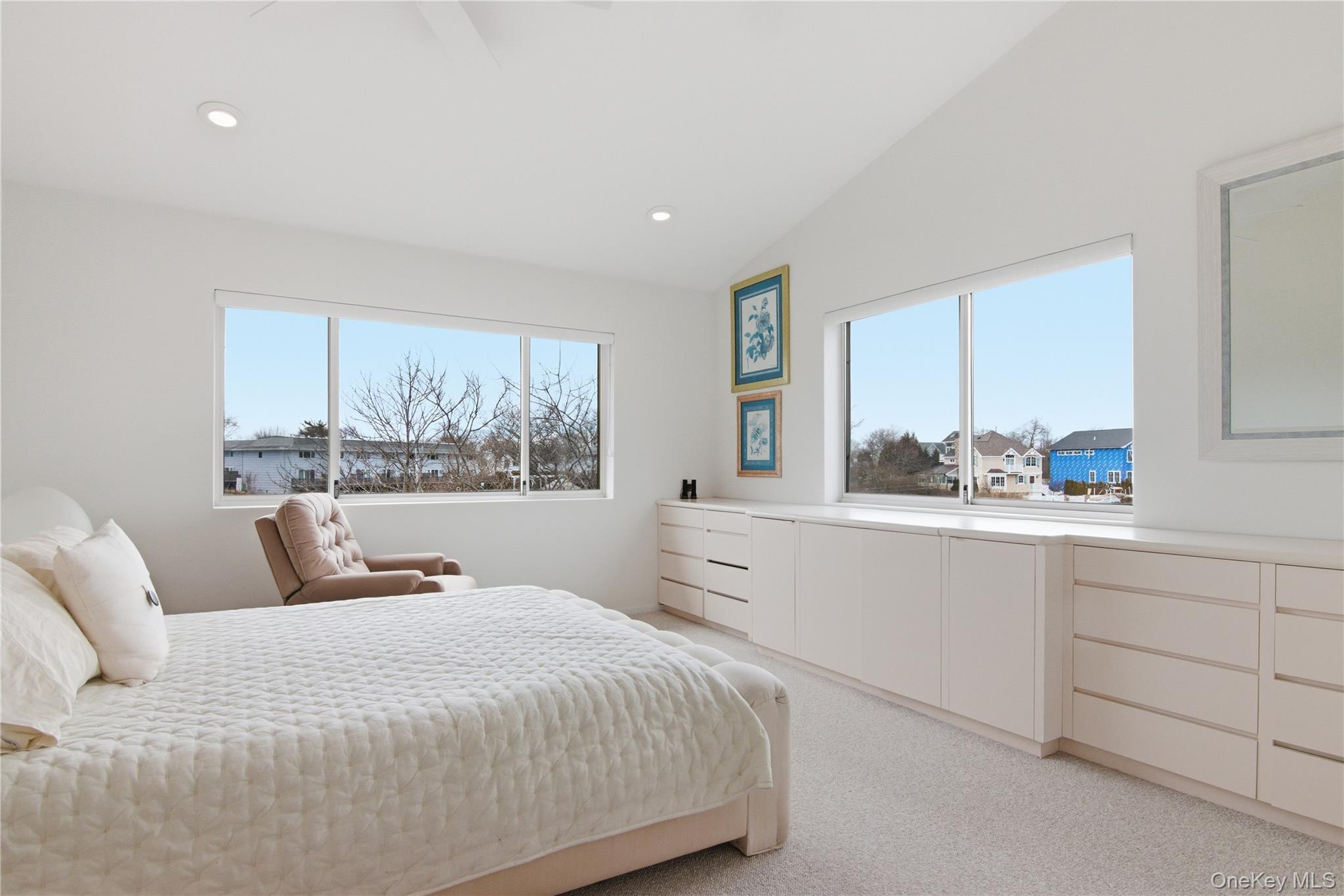 23 Library Avenue, Unit 1 Westhampton Beach, NY 11978 - Photo 16 of 24 Bedroom with multiple windows, lofted ceiling, light carpet, a ceiling fan, and recessed lighting