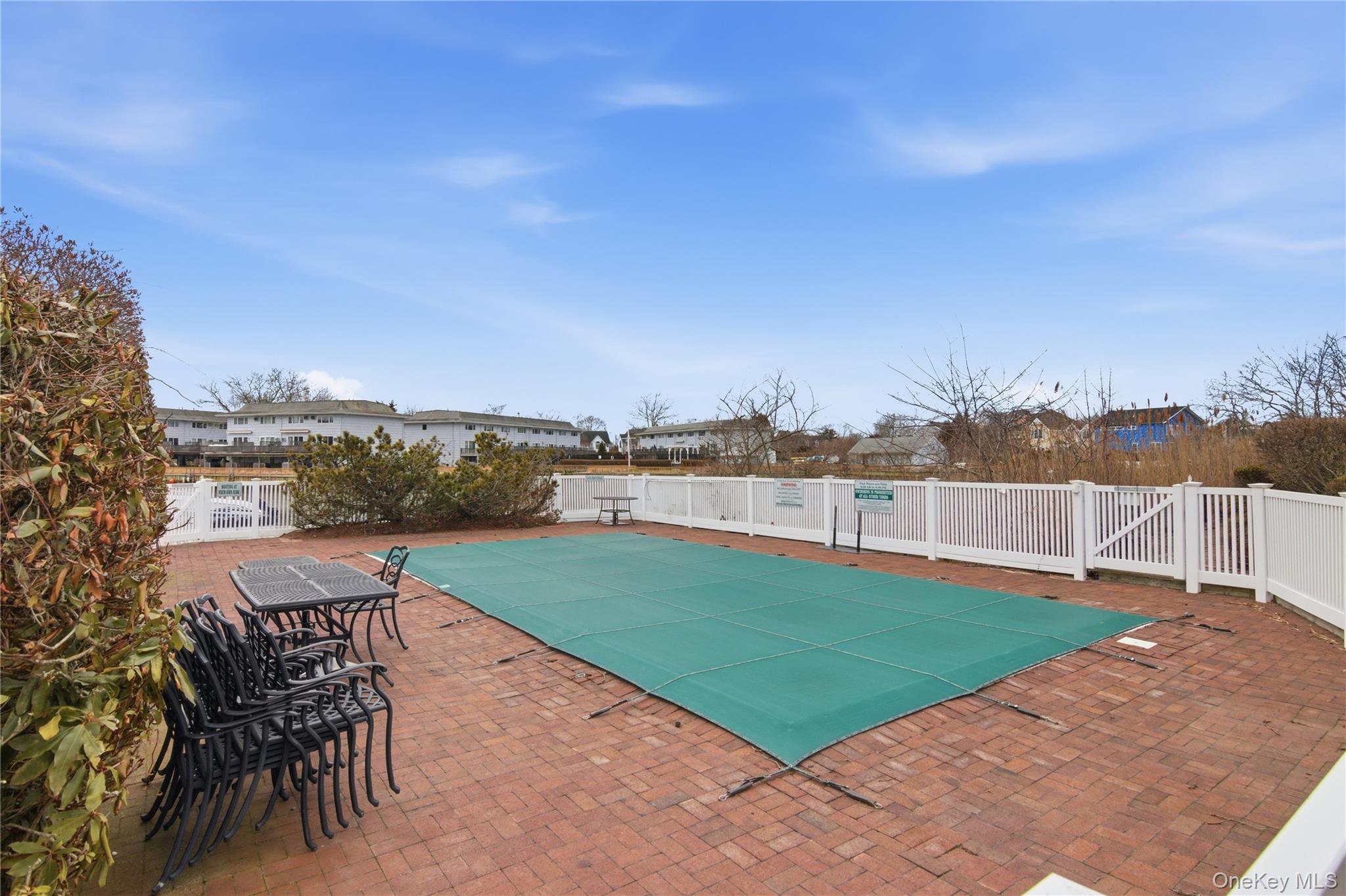 23 Library Avenue, Unit 1 Westhampton Beach, NY 11978 - Photo 19 of 24 Pool with brick patio
