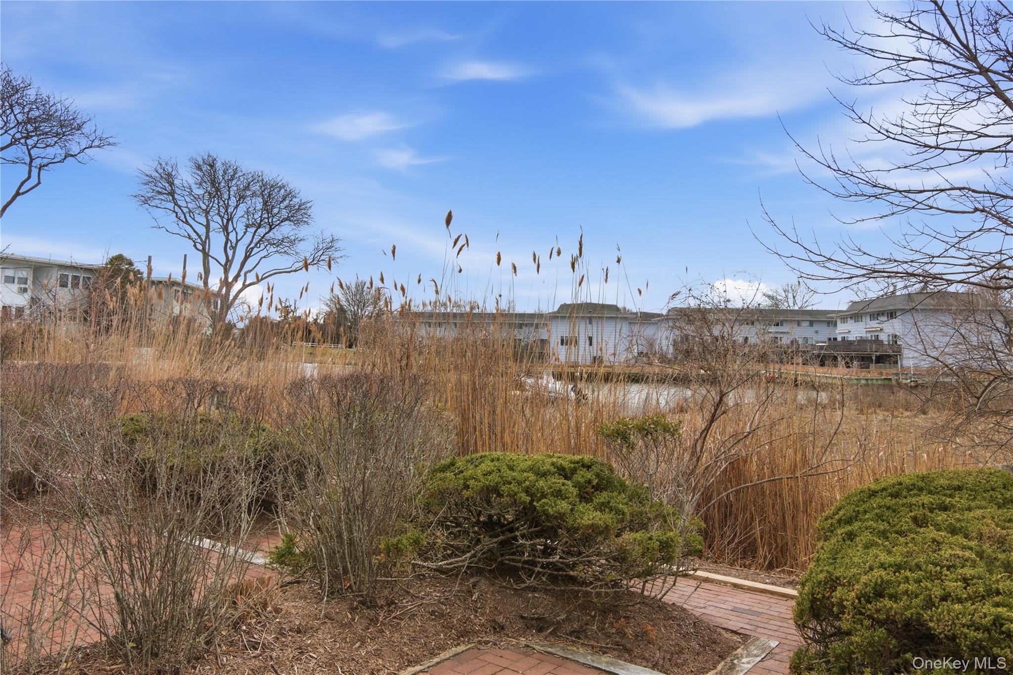 23 Library Avenue, Unit 1 Westhampton Beach, NY 11978 - Photo 20 of 24 View of canal swoon private double patio