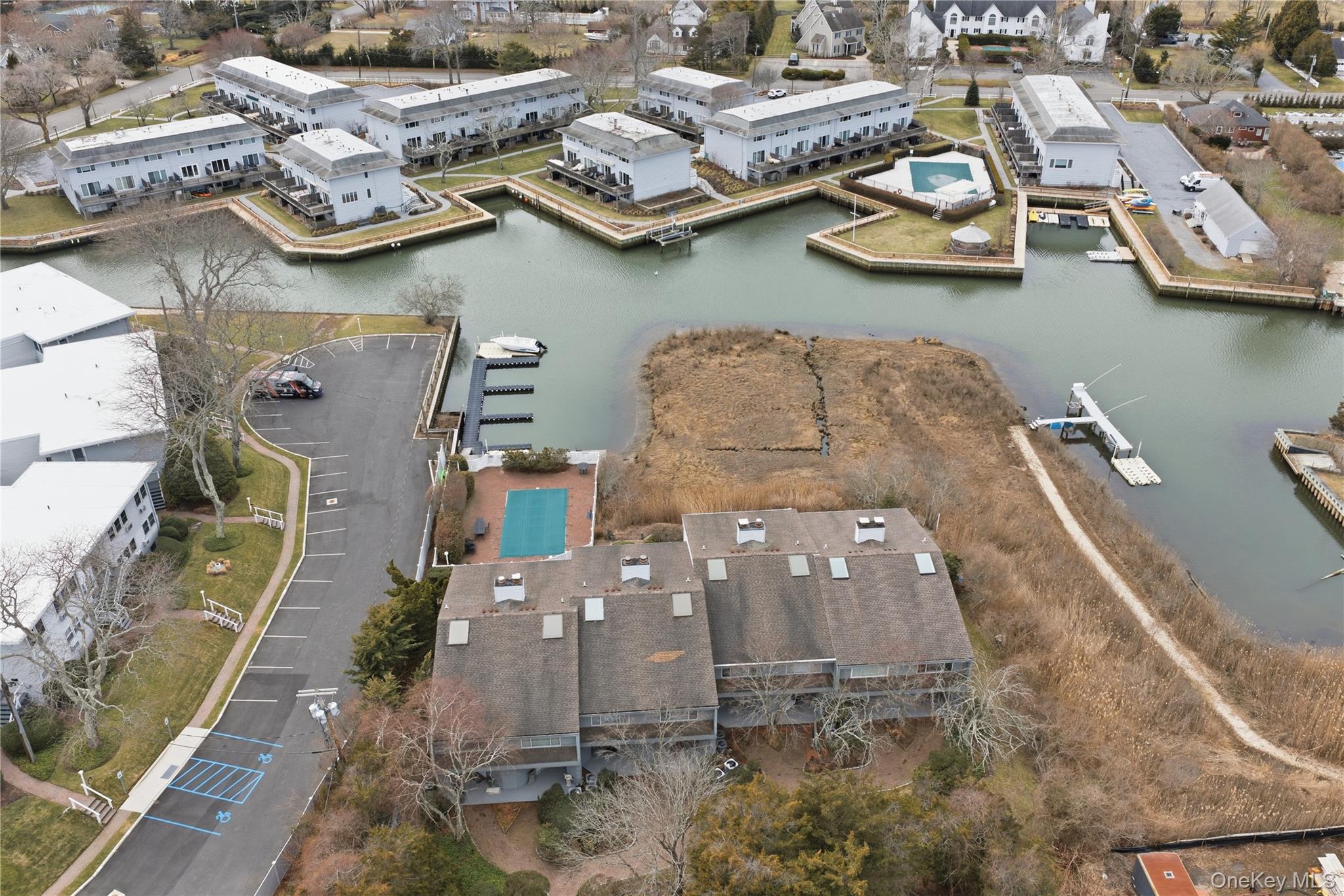 23 Library Avenue, Unit 1 Westhampton Beach, NY 11978 - Photo 22 of 24 Drone / aerial view of a nearby body of water, pool, and dock
