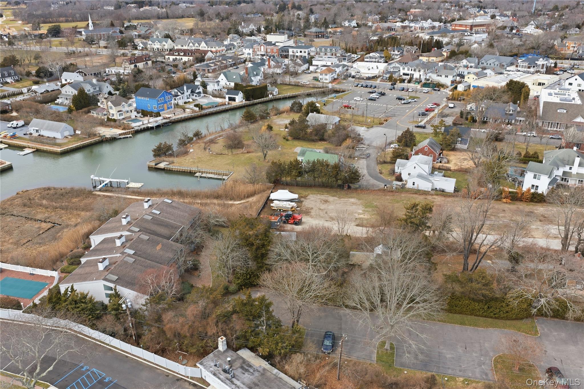 23 Library Avenue, Unit 1 Westhampton Beach, NY 11978 - Photo 23 of 24 Aerial view of property's location featuring nearby village and water