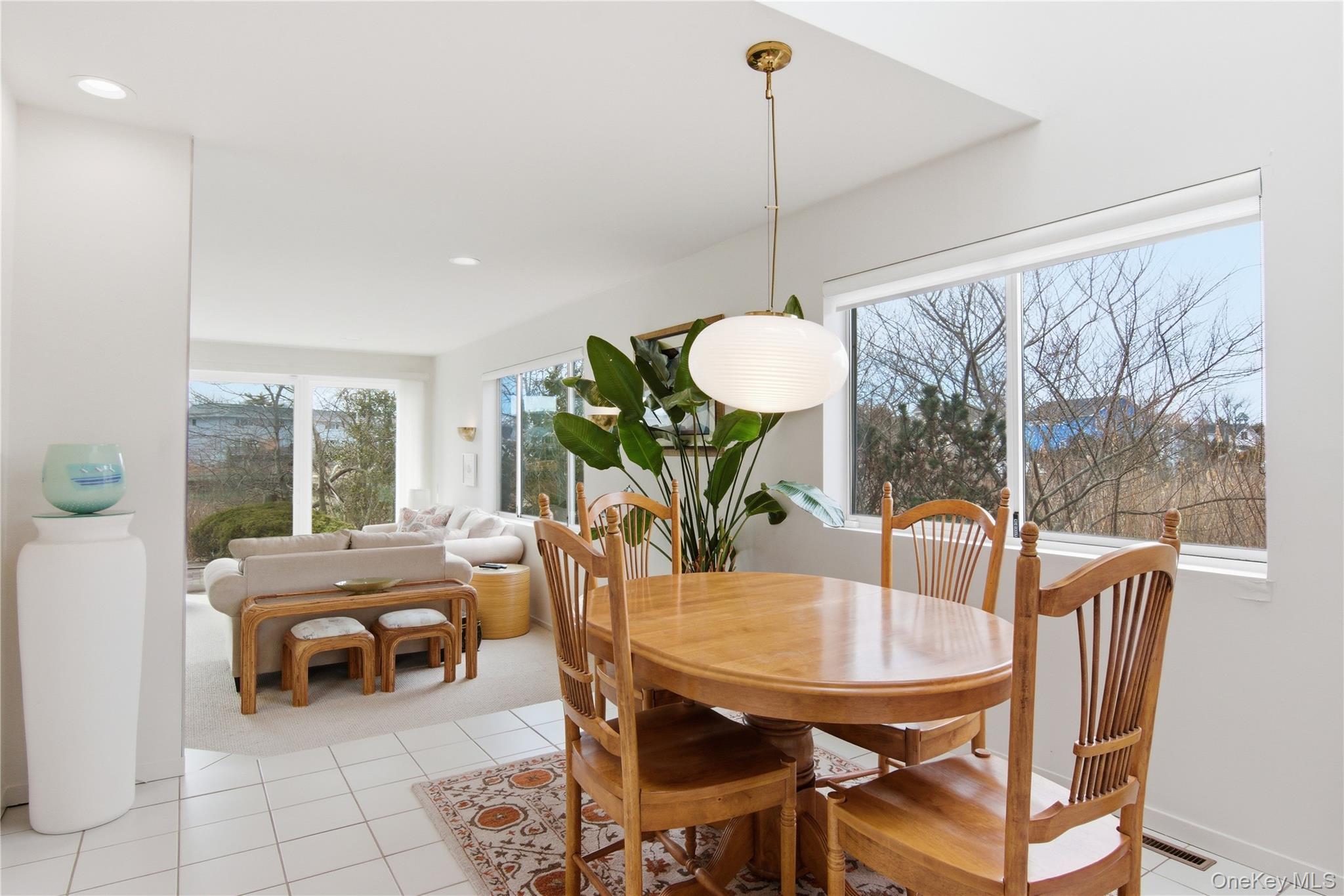 23 Library Avenue, Unit 1 Westhampton Beach, NY 11978 - Photo 10 of 24 Dining room featuring light tile patterned floors