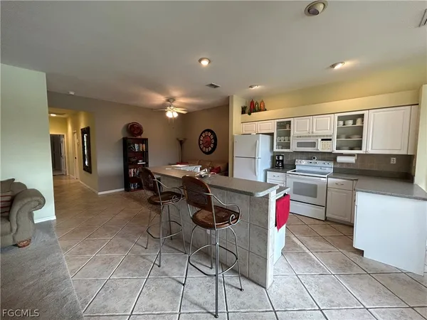 a kitchen with granite countertop a sink cabinets and stainless steel appliances