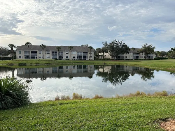 a view of a lake with houses in the back