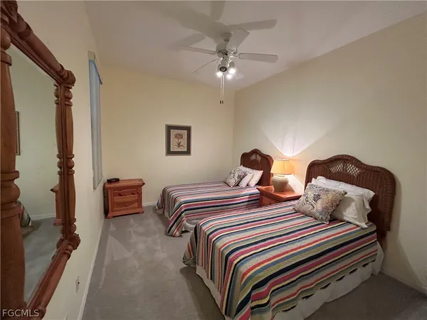 a bedroom with bed and a chandelier