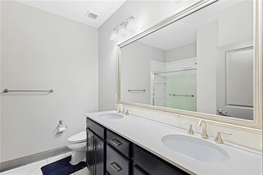 1802 Stephanie Trail Northeast Atlanta, GA 30329 - Photo 12 of 25 a bathroom with a sink a toilet and a mirror